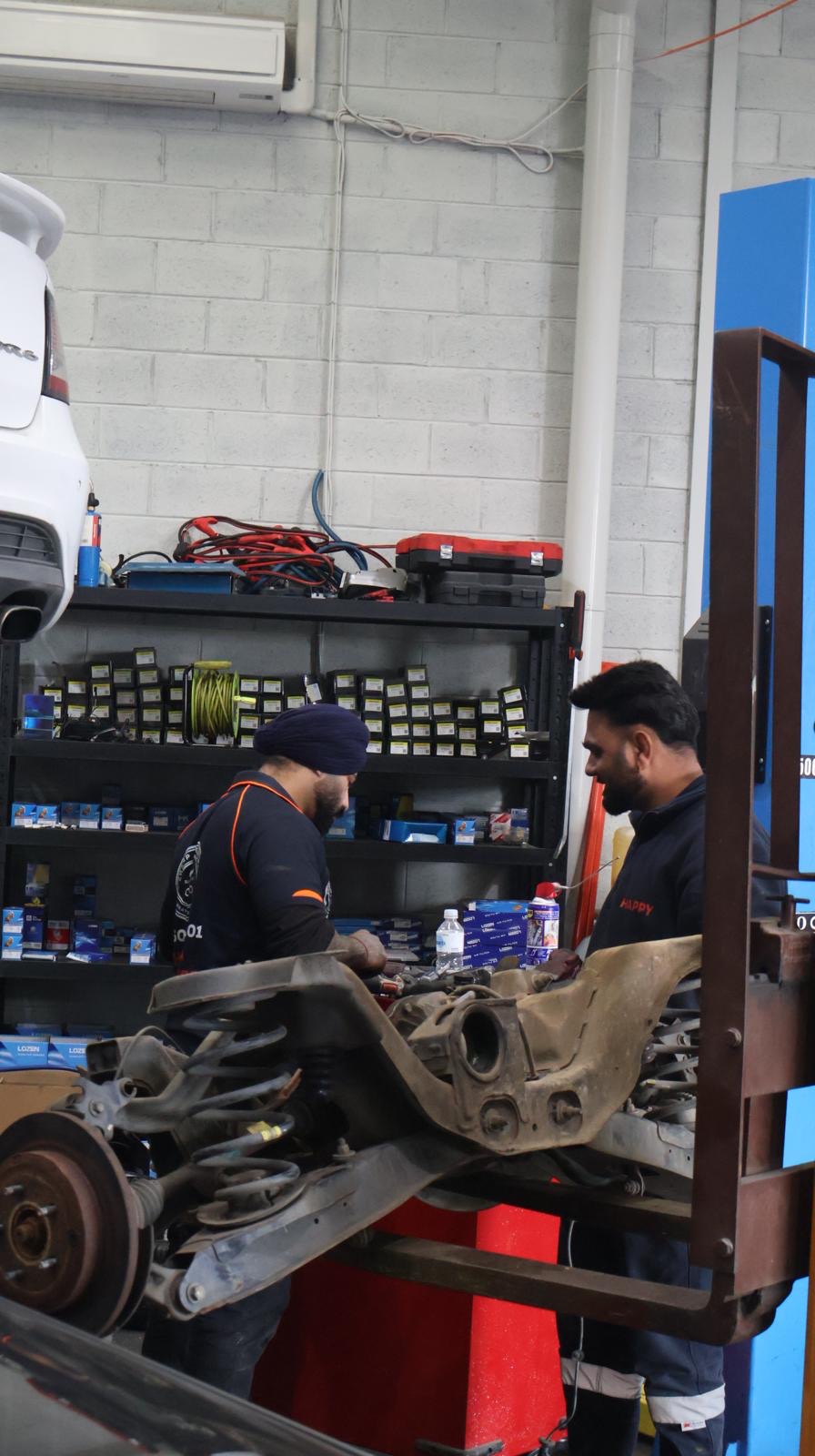 Sharp Autoworks team collaborating on a repair