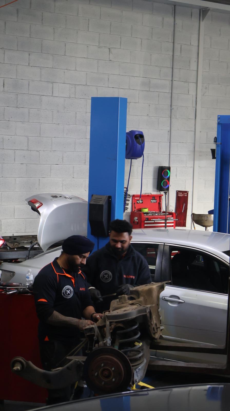 Sharp Autoworks mechanics performing a suspension repair